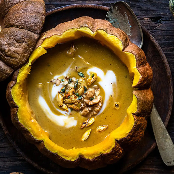 Eine Kaffee-Kürbis-Suppe wurde in einen Kürbis gegossen und mit Sonnenblumenkernen und Walnüssen garniert